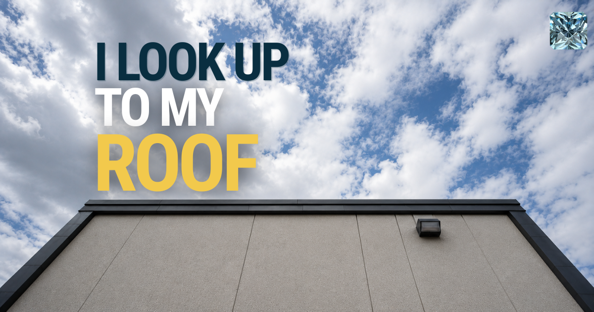 I look up to my roof: commercial building roofline against a cloudy sky