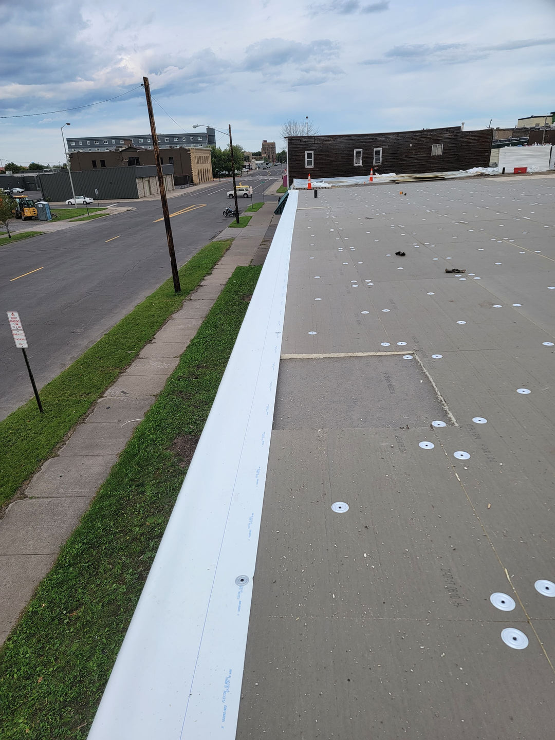 New TPO roofing membrane being mechanically fastened on commercial flat roof — completed installation by Pristine Industrial Roofing.