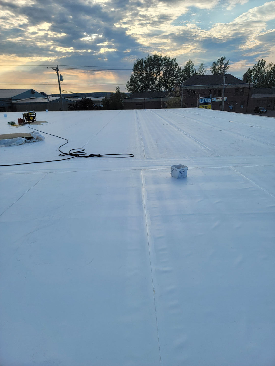 Completed commercial flat roof replacement with white TPO membrane — finished installation by Pristine Industrial Roofing.