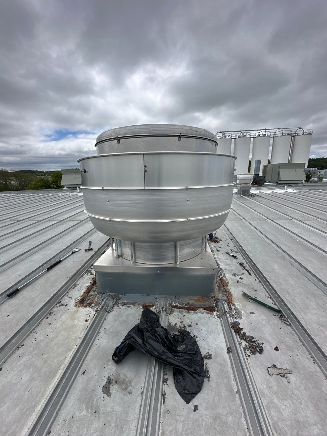 Industrial roof ventilation turbine with rust staining at base