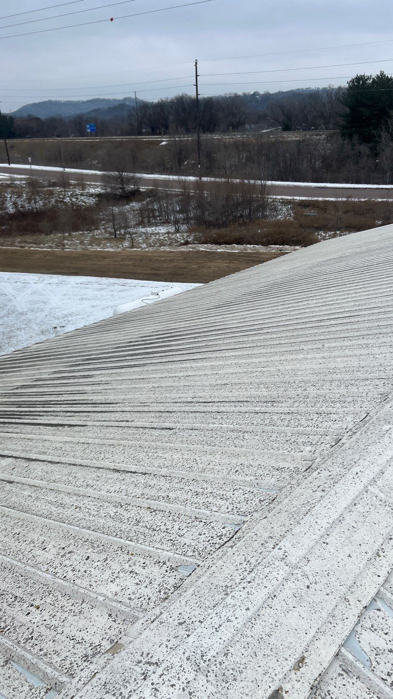 Flaking paint on a corrugated metal roof in winter